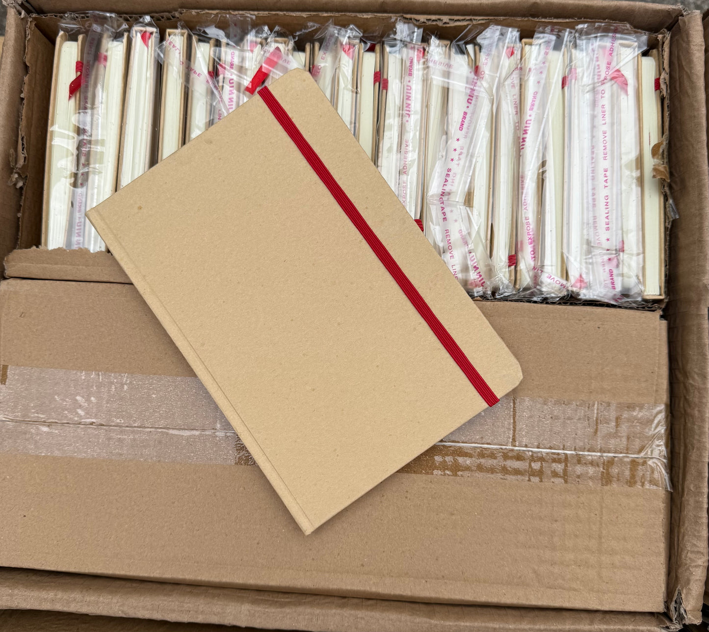 BOX OF 50 A5 HARDBACK NOTEBOOKS WITH RED ELASTIC CLOSURE