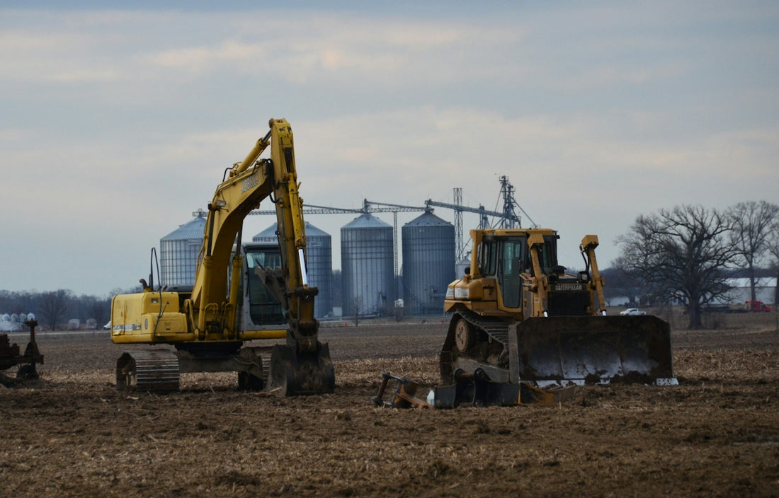 a tractor and a bulldozer in a field