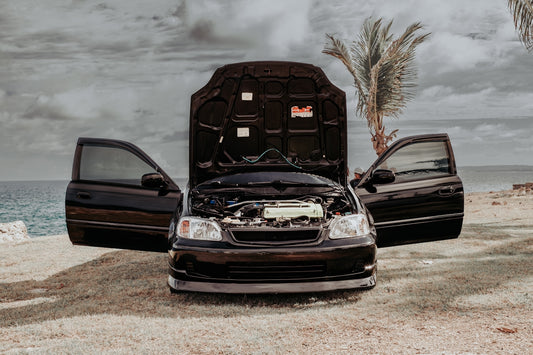 a couple of cars parked next to each other on a beach