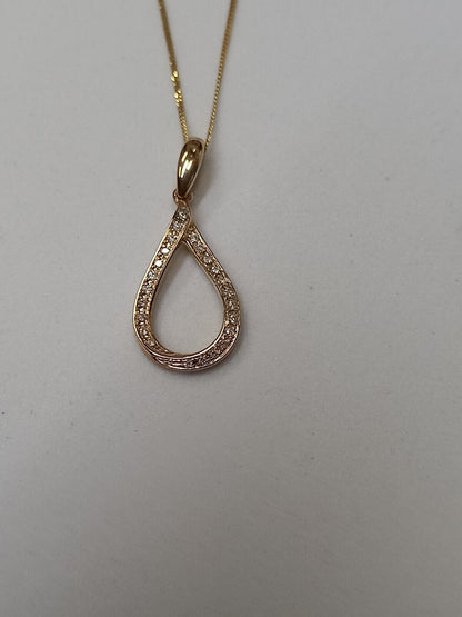 0.09CT DIAMOND TWIST PENDANT /9CT YELLOW GOLD IN GIFT BOX WITH VALUATION CERTIFICATE OF £895