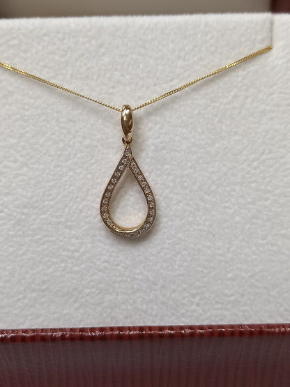 0.09CT DIAMOND TWIST PENDANT /9CT YELLOW GOLD IN GIFT BOX WITH VALUATION CERTIFICATE OF £895