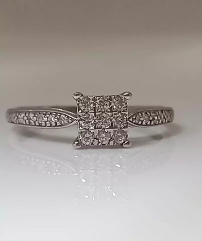 0.20CT DIAMOND CLUSTER RING. 9CT WHITE GOLD SIZE N